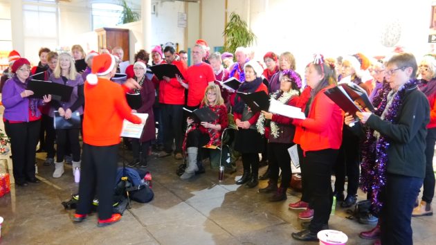 Christmas Singing in Saltaire, 2018, complete with Santa hats and tinsel.